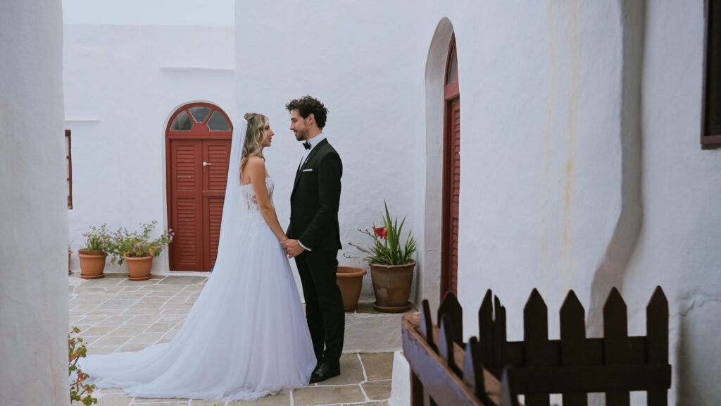 Bride and groom sharing a first look outside a traditional Cycladic church, Sifnos, Greece