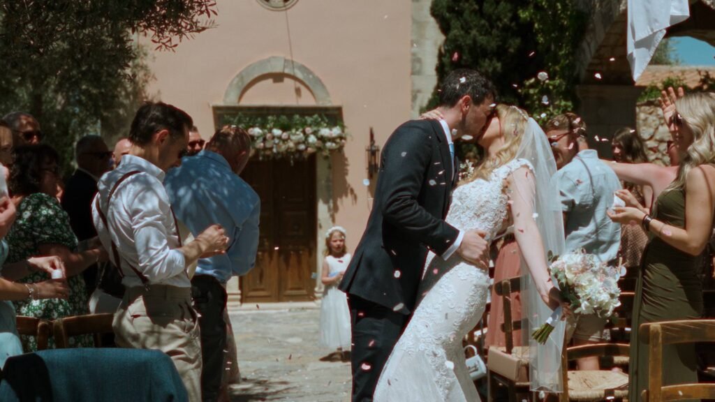 Bride and groom dip kiss at the church of St Nicholas, Agreco Farms wedding venue, Crete